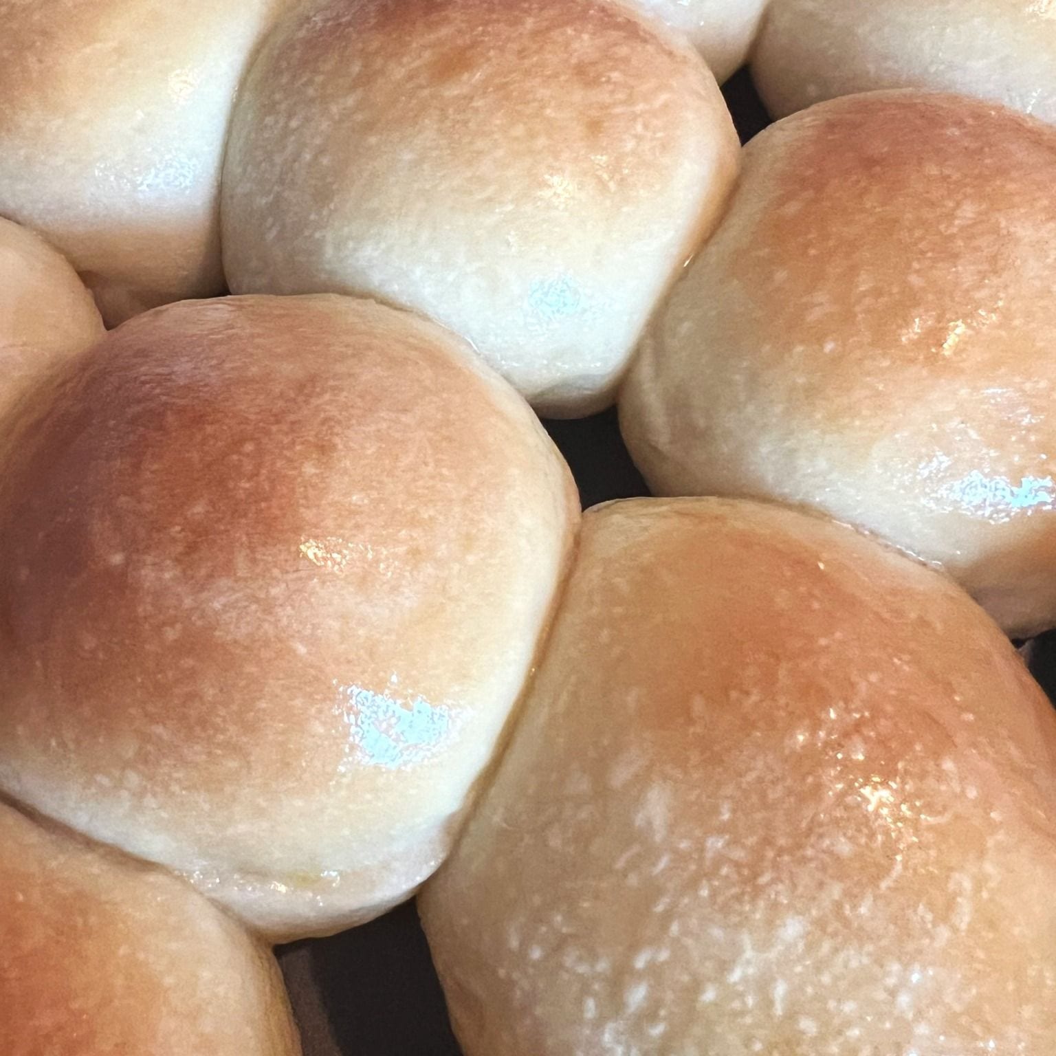 Soft sourdough Hawaiian-style rolls in a baking pan