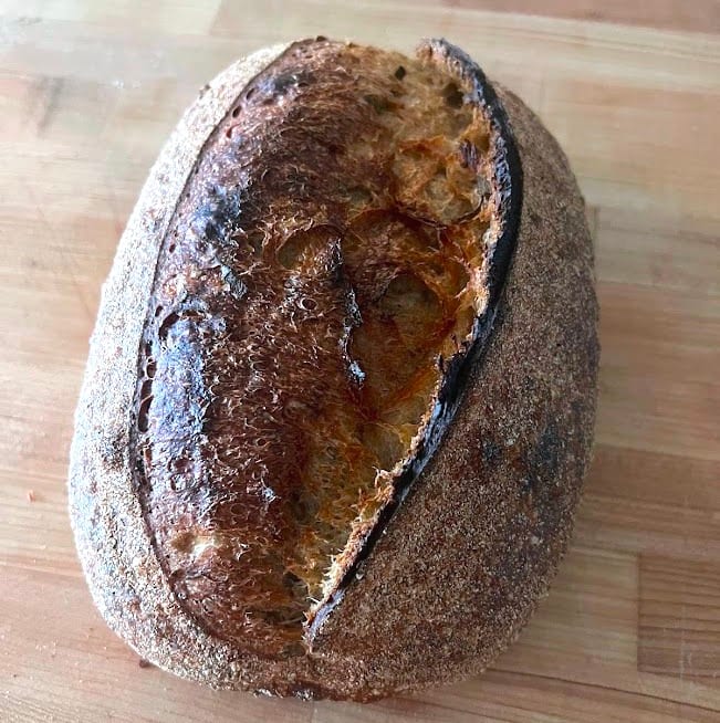 Baked herb-loaded sourdough loaf
